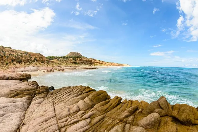 vista de la playa de cabo pulmo. se ve el agua celeste y unas rocas alrededor